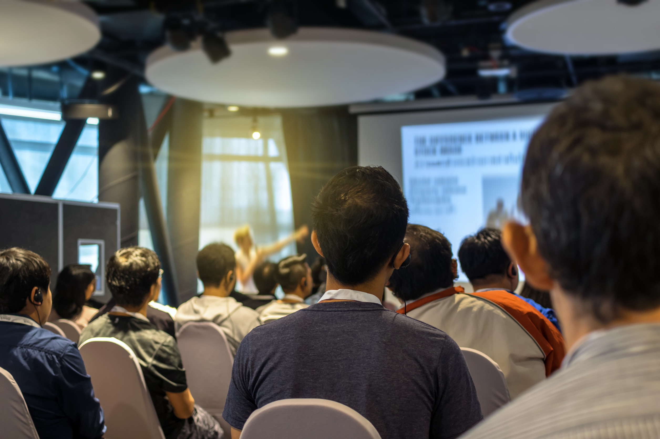 Closeup some attendee over the Abstract blurred photo of confere